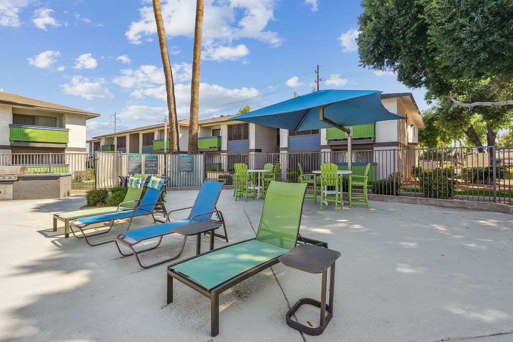 our apartments have a patio with chairs and umbrellas
